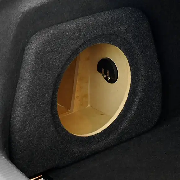 A custom build car audio enclosure in a boot with carpeting finish.