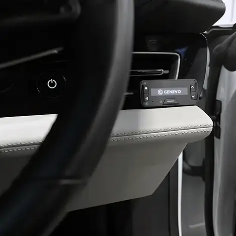 The Genevo Pro II radar detector stealth installed next to a driving wheel.